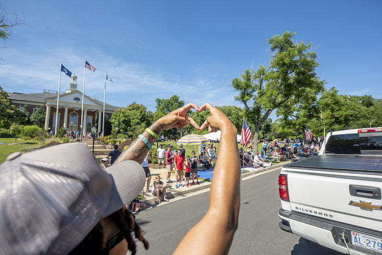 GMU participanting in 4th of July Parade. Participants include the Women's basketball team, The Green Machine, Emerald Desire Dance Team, Mason wrestlers, the Patriot, Mason Police, faculty/staff, students, and alumni. Photo by: Sierra Guard/Creative Services/George Mason University